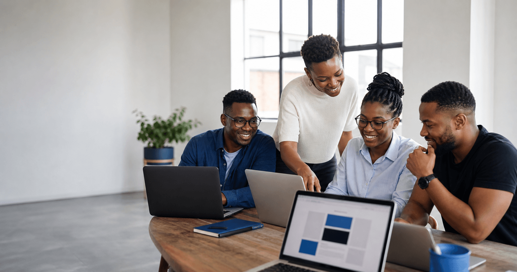 Professionals learning together around laptops